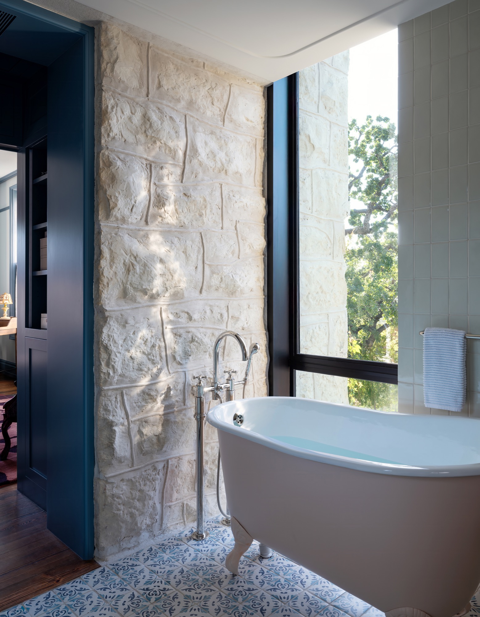 Victorian House clawfoot tub against stone wall in Austin, Texas